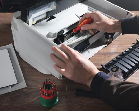 a man is working on a machine with tools