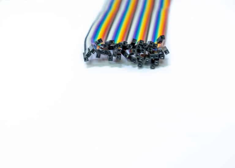 a group of multicolored wires on a white surface
